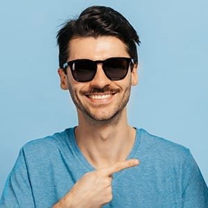 Smiling man in blue t-shirt, representing a quick and easy way to get a visa online, Schengen or UK ETA